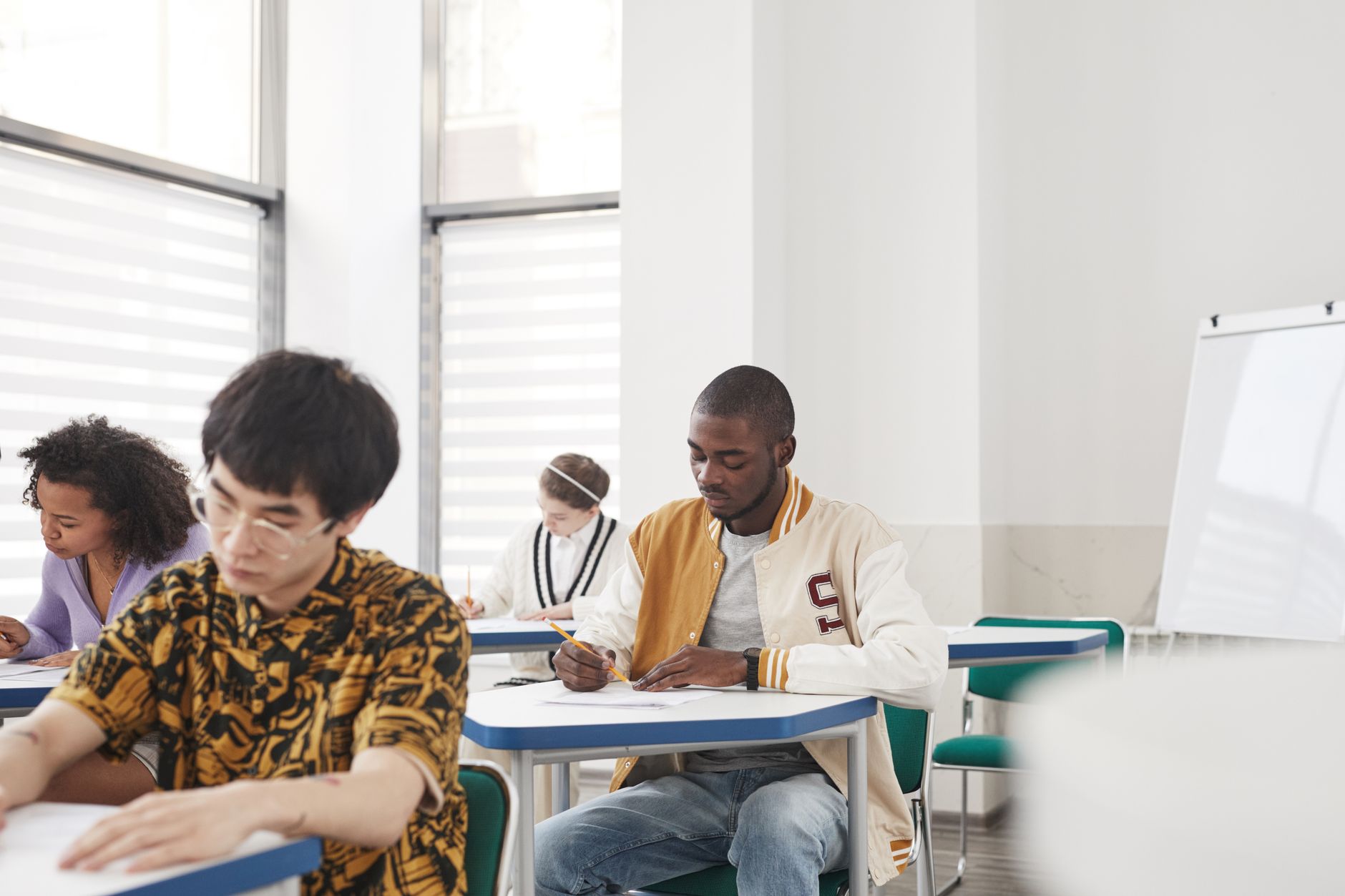 Students writing a practice test in a quiet classroom